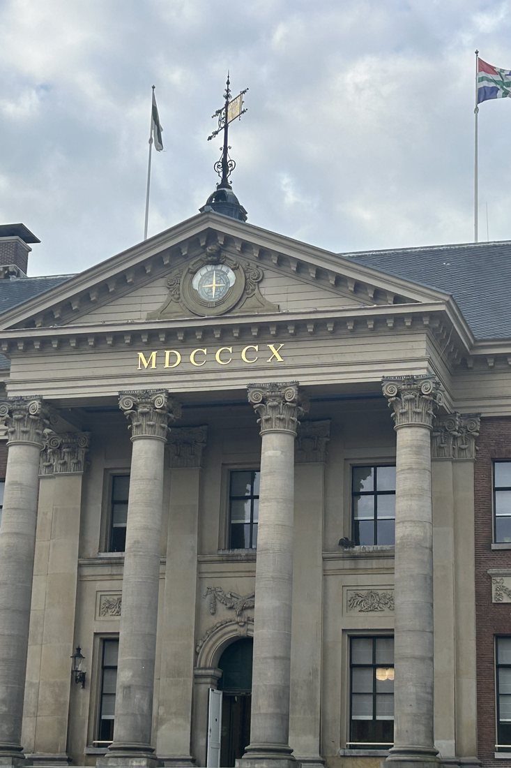 Groningen's City Hall on the Grote Markt, MDCCCX in gold above the columns.